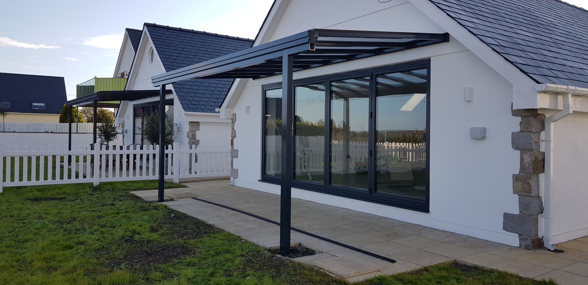 Anthracite grey Simplicity 6 veranda over a patio seating area